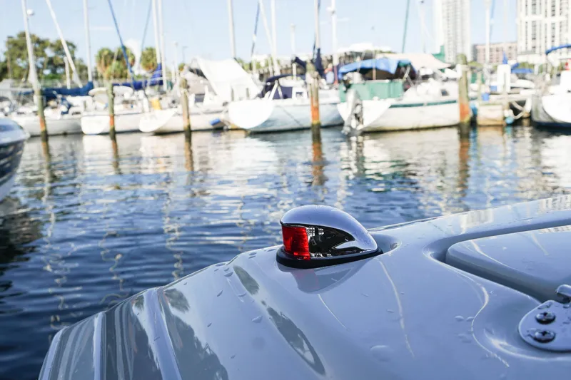 Slide: The Image of 2026 Crownline 288 SS boat docked in a marina, surrounded by other vessels. - 13
