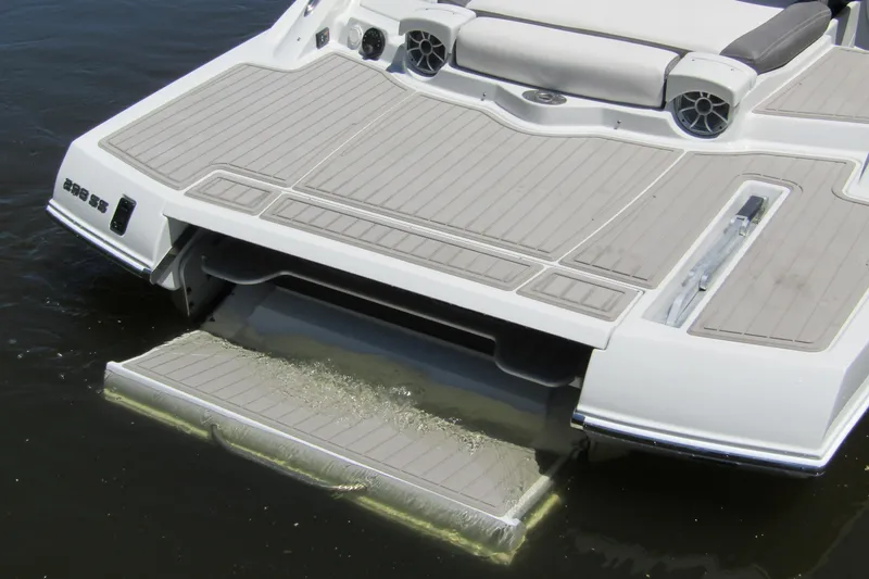 Slide: The Image of 2026 Crownline 288 SS boat with swim platform and speakers on water. - 2