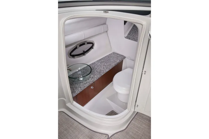 Slide: The Image of 2026 Crownline 288 SS boat interior bathroom with modern sink and toilet. - 5
