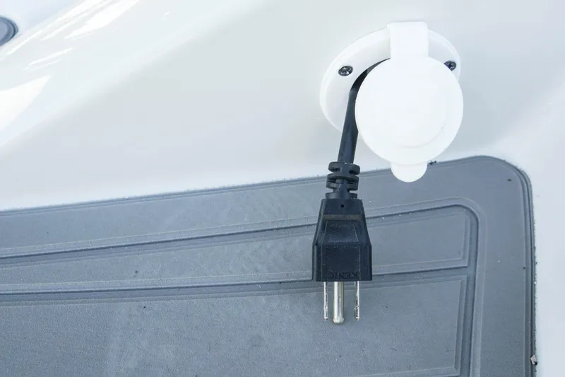 Slide: The Image of Power plug on 2026 Crownline 288 SS boat, connected to a white outlet. - 7