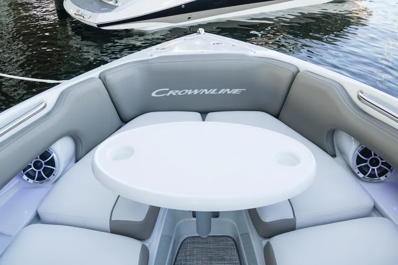 Slide: The Image of 2026 Crownline 288 SS boat interior with seating and table on water. - 9