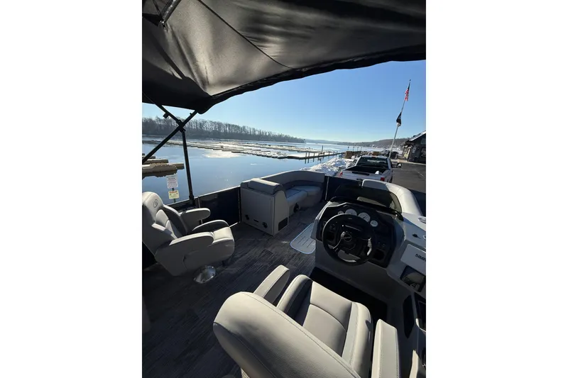 Slide: The Image of 2026 Bentley Pontoons Legacy 243 Navigator on a serene waterfront, showcasing luxurious seating. - 11