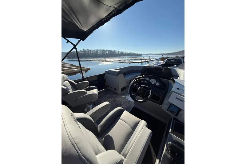 Slide: The Image of 2026 Bentley Pontoons Legacy 243 Navigator interior with lake view and modern helm. - 4