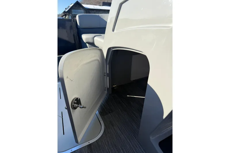 Slide: The Image of Open storage compartment on 2026 Bentley Pontoons Legacy 243 Navigator boat. - 9