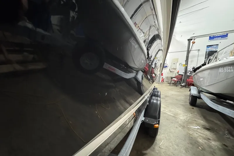 Slide: The Image of 2016 Sea Ray SPX 210 Outboard boat in a garage, side view reflection. - 13