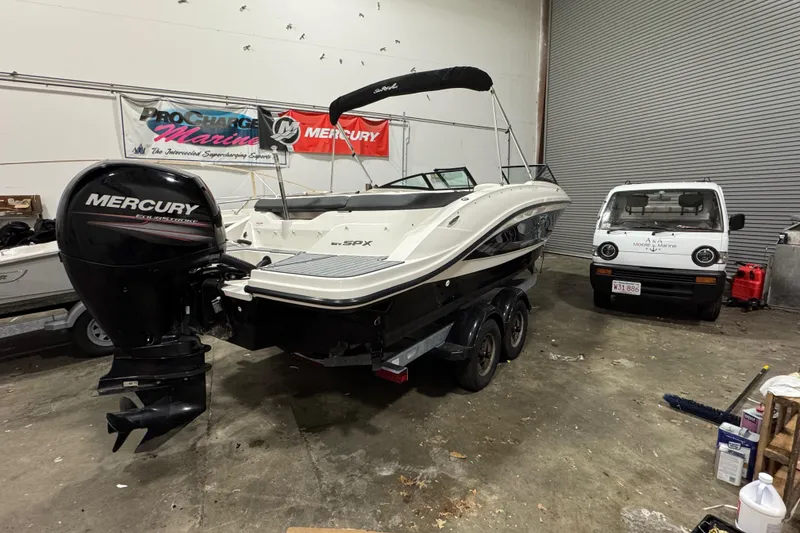 Slide: The Image of 2016 Sea Ray SPX 210 Outboard boat with Mercury engine in a garage. - 14