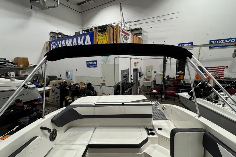 Slide: The Image of 2016 Sea Ray SPX 210 Outboard boat interior in a workshop setting. - 17