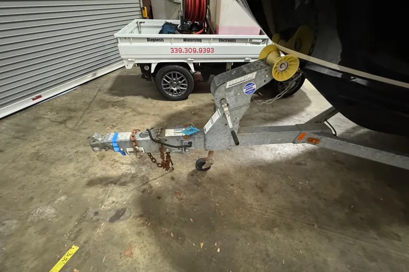 Slide: The Image of Trailer hitch of a 2016 Sea Ray SPX 210 Outboard in a garage setting. - 27