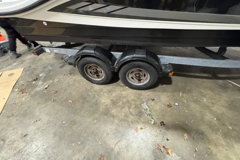 Slide: The Image of Trailer for 2016 Sea Ray SPX 210 Outboard boat in a garage setting. - 29