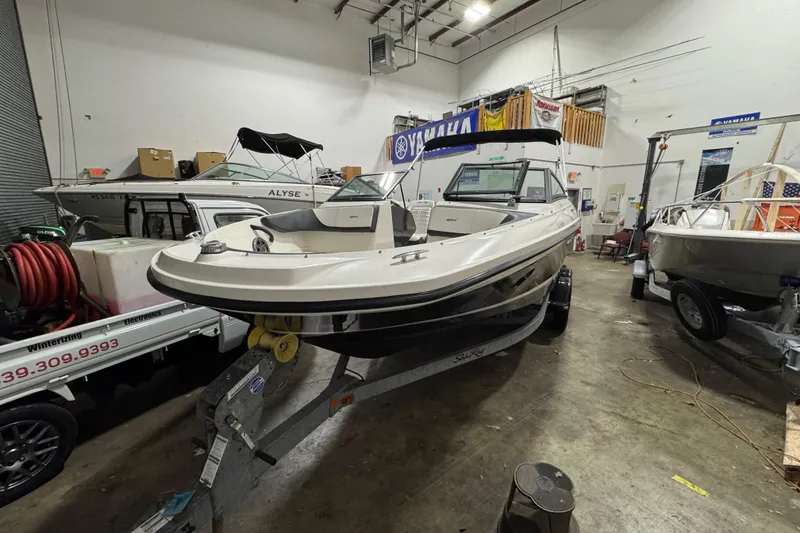 Slide: The Image of 2016 Sea Ray SPX 210 Outboard boat on trailer in indoor storage facility. - 6