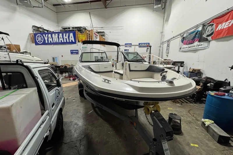 Slide: The Image of 2016 Sea Ray SPX 210 Outboard boat in a workshop with Yamaha signage. - 7