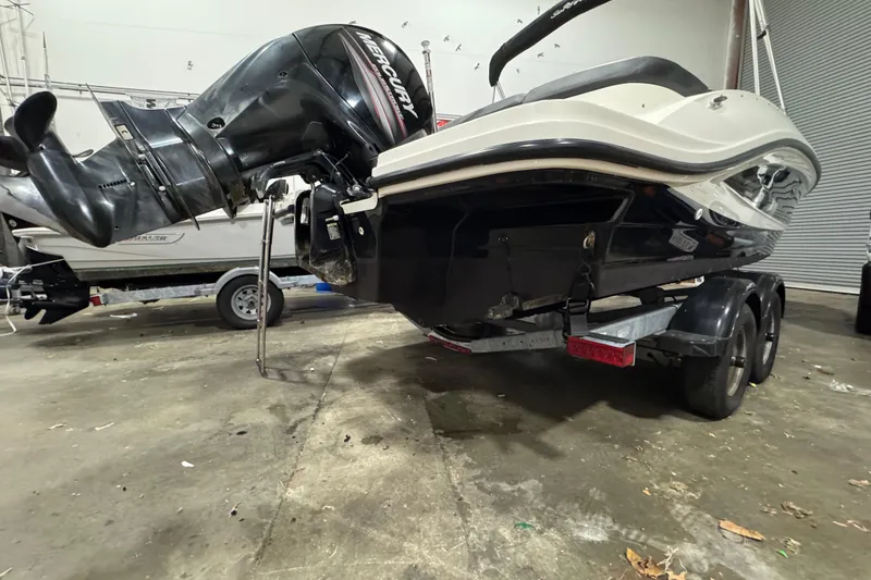 Slide: The Image of 2016 Sea Ray SPX 210 Outboard boat on trailer, featuring a powerful Mercury engine. - 8
