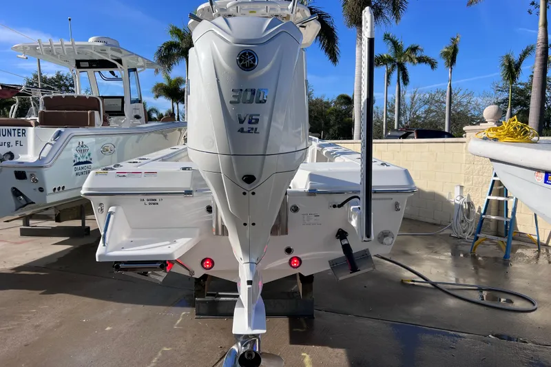 Slide: The Image of 2024 Everglades 243 Center Console boat with Yamaha 300 V6 engine, docked outdoors. - 1