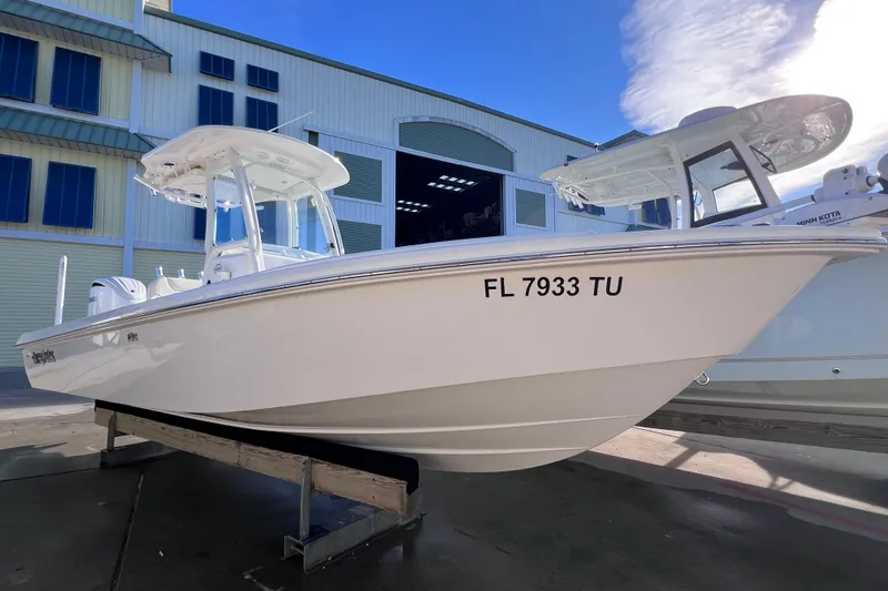 Slide: The Image of 2024 Everglades 243 Center Console boat displayed outdoors, showcasing sleek design and modern features. - 10