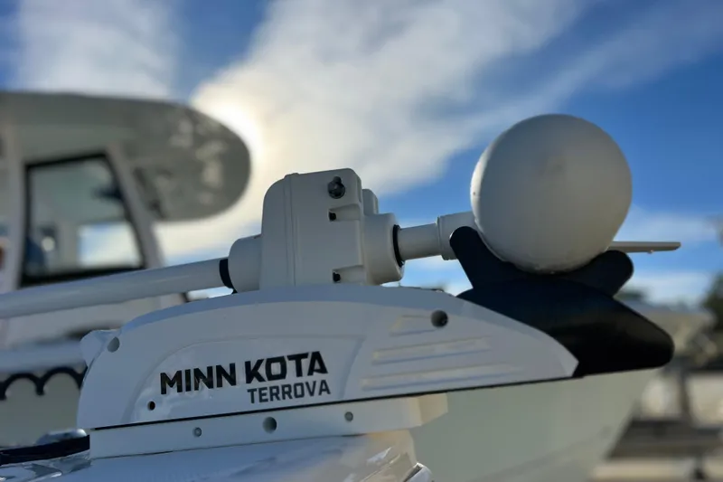 Slide: The Image of Minn Kota Terrova motor on 2024 Everglades 243 Center Console boat under blue sky. - 14