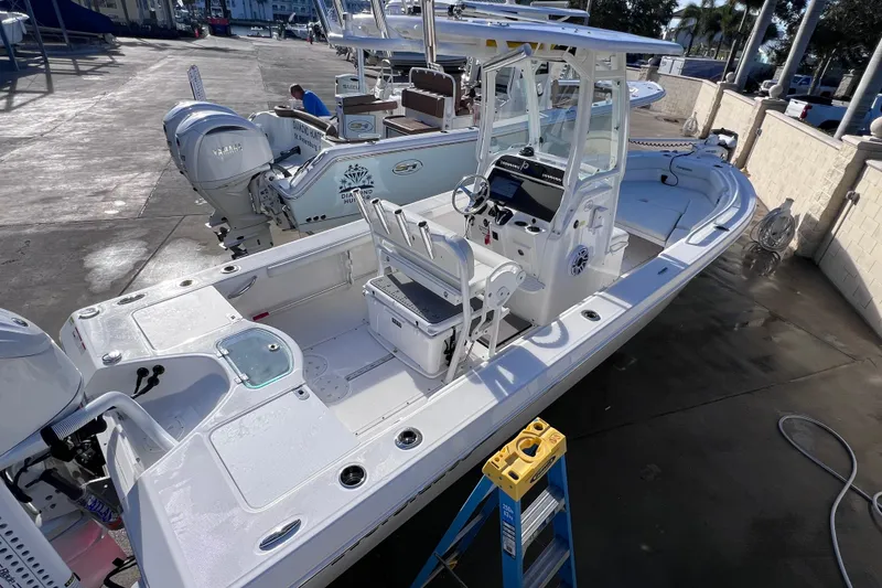 Slide: The Image of 2024 Everglades 243 Center Console boat in marina, showcasing sleek design and modern features. - 17