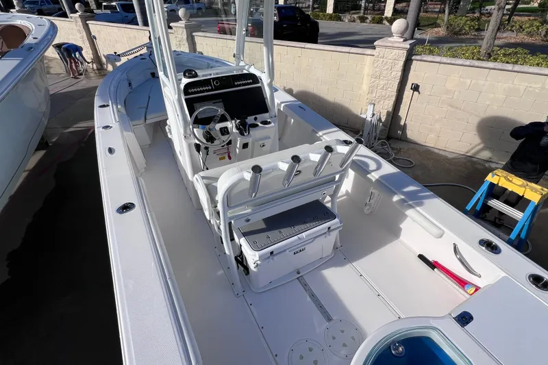 Slide: The Image of 2024 Everglades 243 Center Console boat, featuring spacious deck and modern controls. - 19