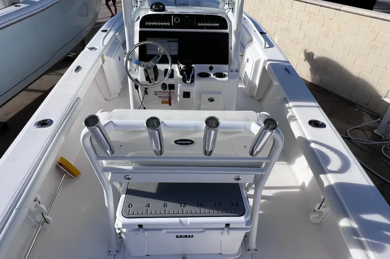 Slide: The Image of 2024 Everglades 243 Center Console boat interior with steering wheel and rod holders. - 20