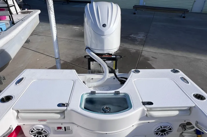 Slide: The Image of 2024 Everglades 243 Center Console boat with Yamaha outboard motor and fishing amenities. - 21