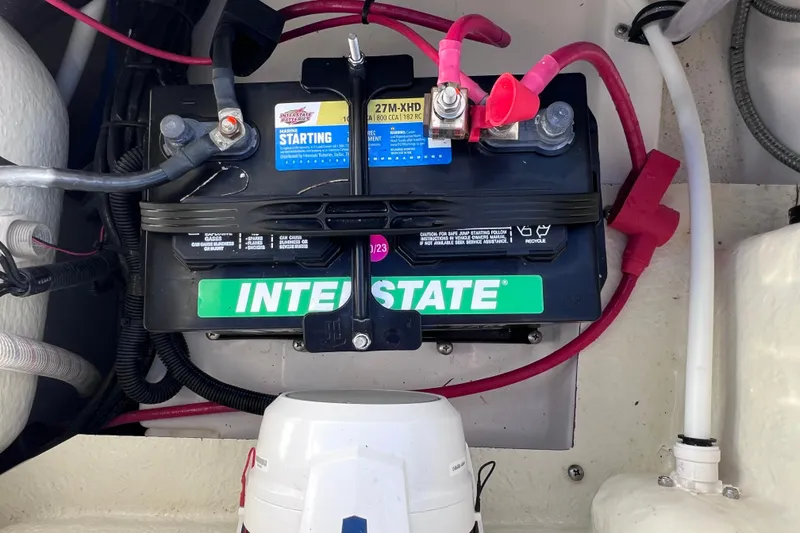Slide: The Image of Battery setup in a 2024 Everglades 243 Center Console boat, featuring Interstate marine battery. - 28