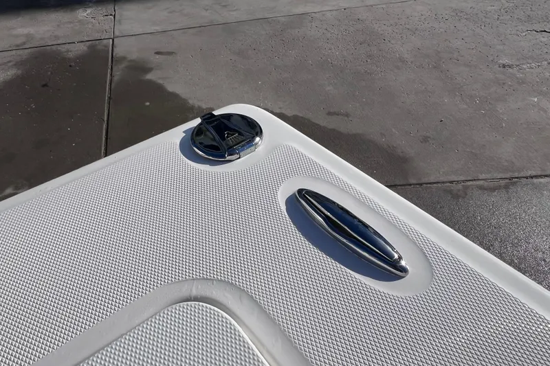Slide: The Image of 2024 Everglades 243 Center Console boat deck with chrome fittings and textured surface. - 31