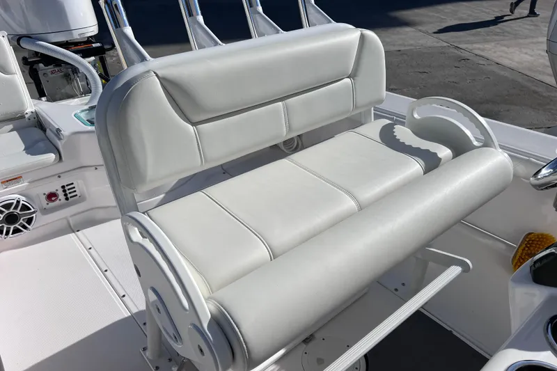 Slide: The Image of 2024 Everglades 243 Center Console boat with white cushioned seating and rod holders. - 48
