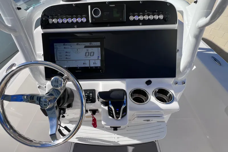 Slide: The Image of 2024 Everglades 243 Center Console dashboard with steering wheel and navigation display. - 50