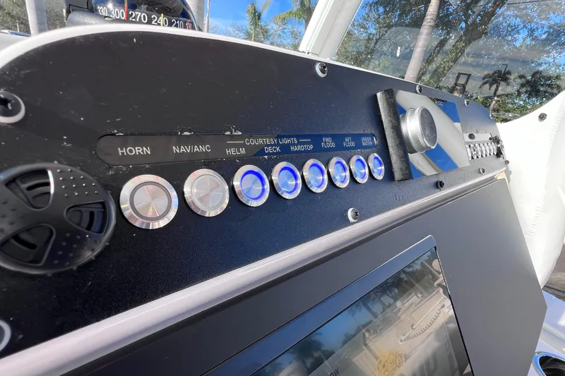 Slide: The Image of 2024 Everglades 243 Center Console dashboard with control buttons and navigation instruments. - 51