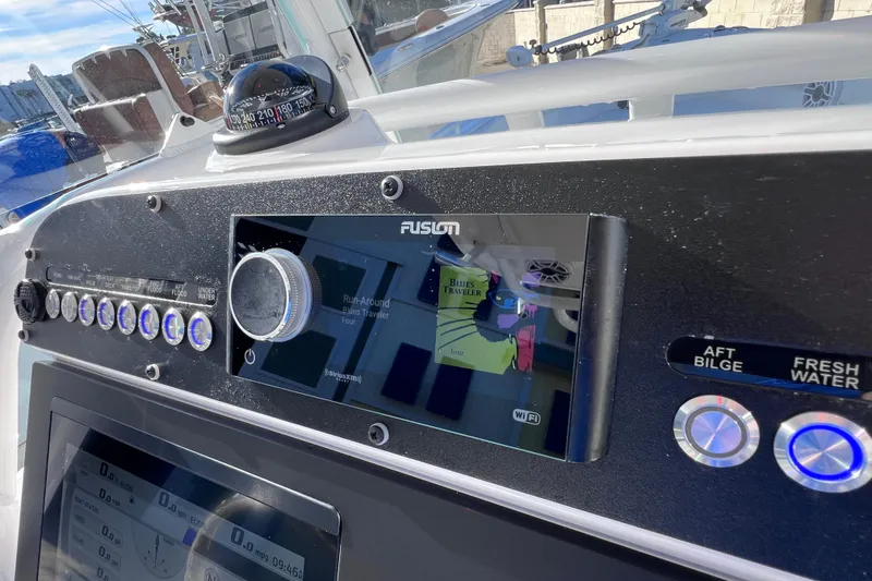 Slide: The Image of 2024 Everglades 243 Center Console dashboard with Fusion stereo and navigation controls. - 53