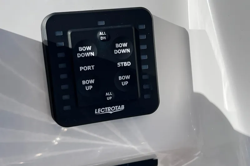 Slide: The Image of Control panel of 2024 Everglades 243 Center Console boat with Lectrotab trim tab switches. - 54
