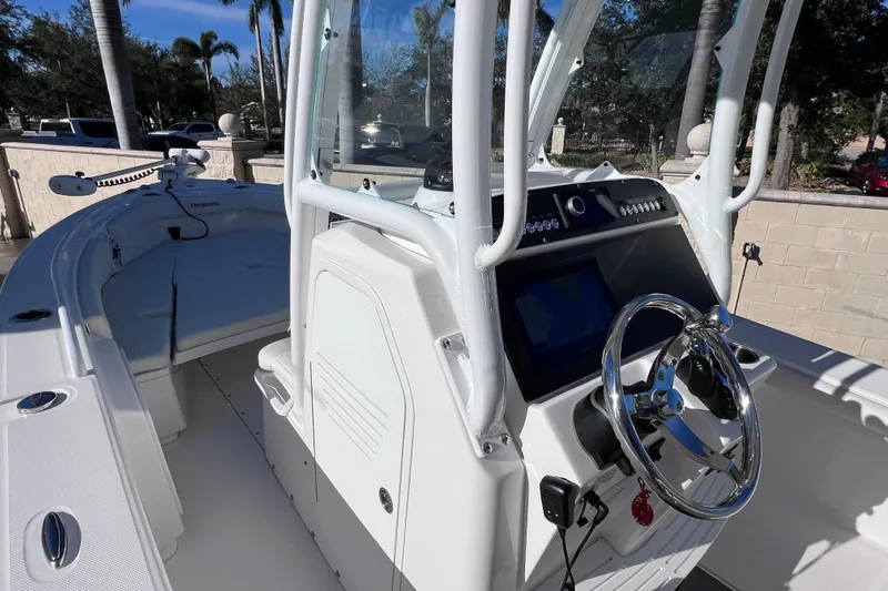 Slide: The Image of 2024 Everglades 243 Center Console boat with sleek helm and modern controls. - 63