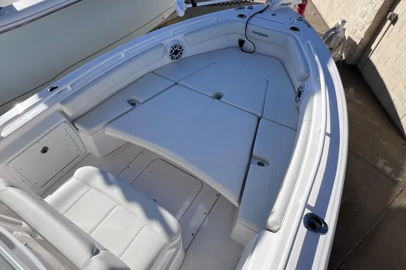 Slide: The Image of 2024 Everglades 243 Center Console boat interior with white seating and storage compartments. - 65