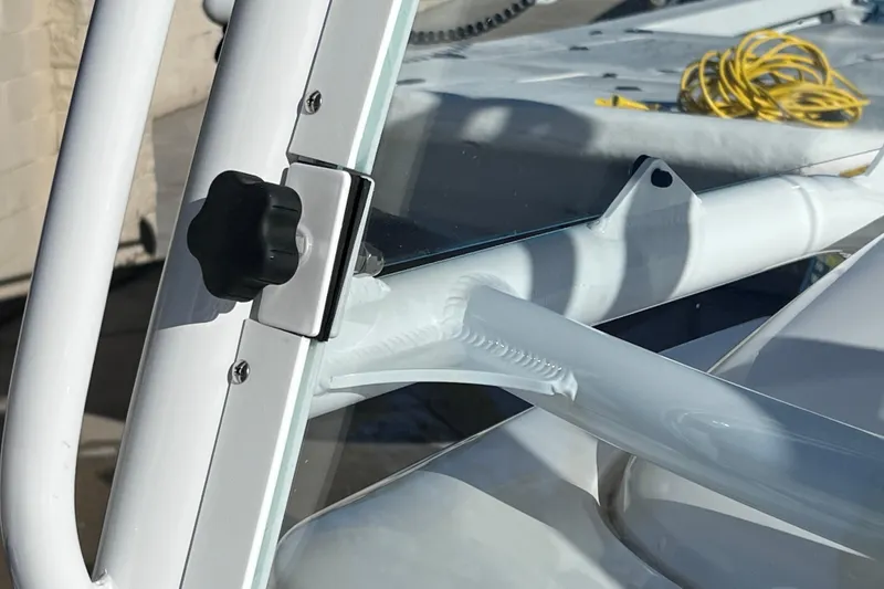 Slide: The Image of Close-up of 2024 Everglades 243 Center Console boat's windshield and frame detail. - 68