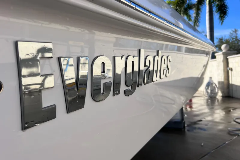 Slide: The Image of 2024 Everglades 243 Center Console boat with reflective logo in sunlight. - 7