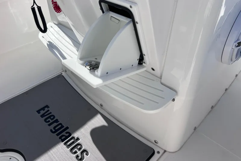 Slide: The Image of 2024 Everglades 243 Center Console boat interior with storage compartment and branded mat. - 78