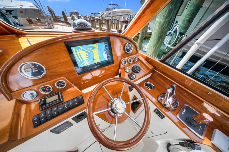 Slide: The Image of Helm of 2020 Hinckley Picnic Boat 34 MKII with wooden dashboard and navigation display. - 12