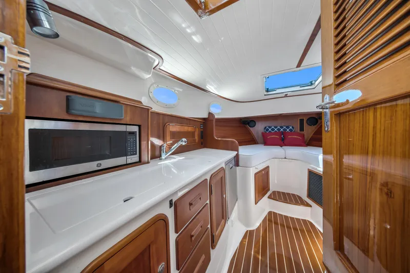 Slide: The Image of Interior of 2020 Hinckley Picnic Boat 34 MKII with wood finish and modern amenities. - 14