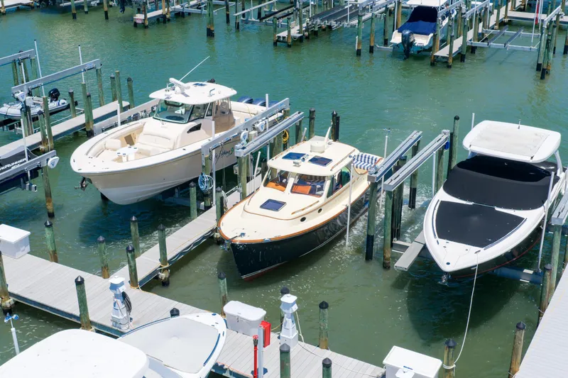 Slide: The Image of 2020 Hinckley Picnic Boat 34 MKII docked among other boats in a marina. - 3