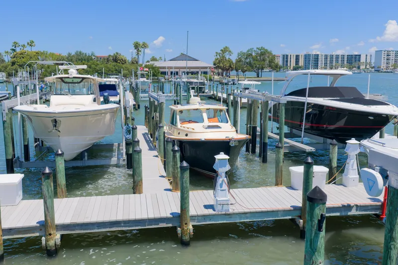 Slide: The Image of Hinckley Picnic Boat 34 MKII 2020 docked among other boats at a marina. - 4