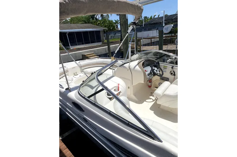 Slide: The Image of 2007 Hurricane SunDeck 237 OB boat interior with steering wheel and seating. - 3