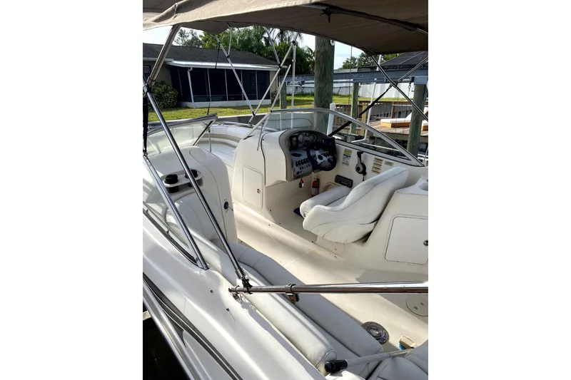 Slide: The Image of 2007 Hurricane SunDeck 237 OB boat interior with steering console and seating. - 4