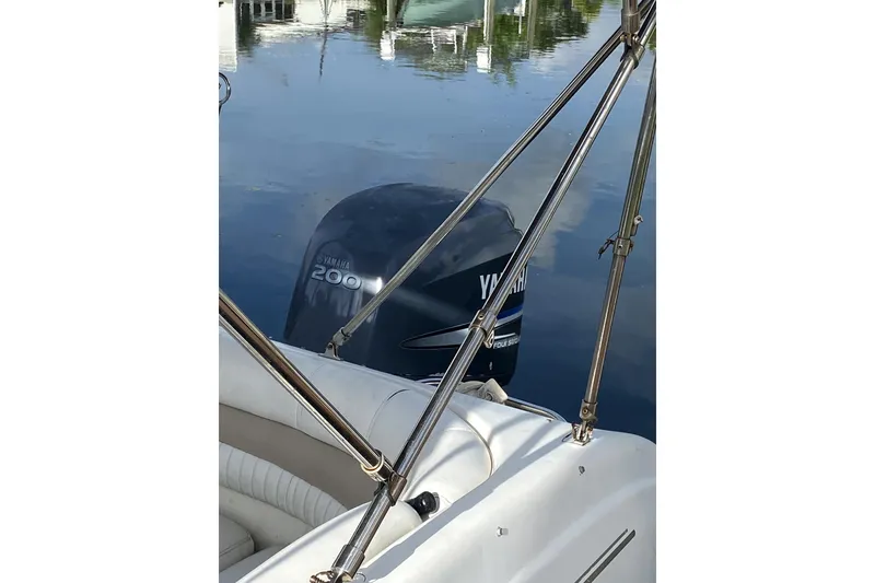 Slide: The Image of 2007 Hurricane SunDeck 237 OB with Yamaha 200 outboard motor on calm water. - 5