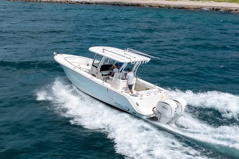 Slide: The Image of 2023 Robalo R302 Center Console boat cruising on open water. - 1