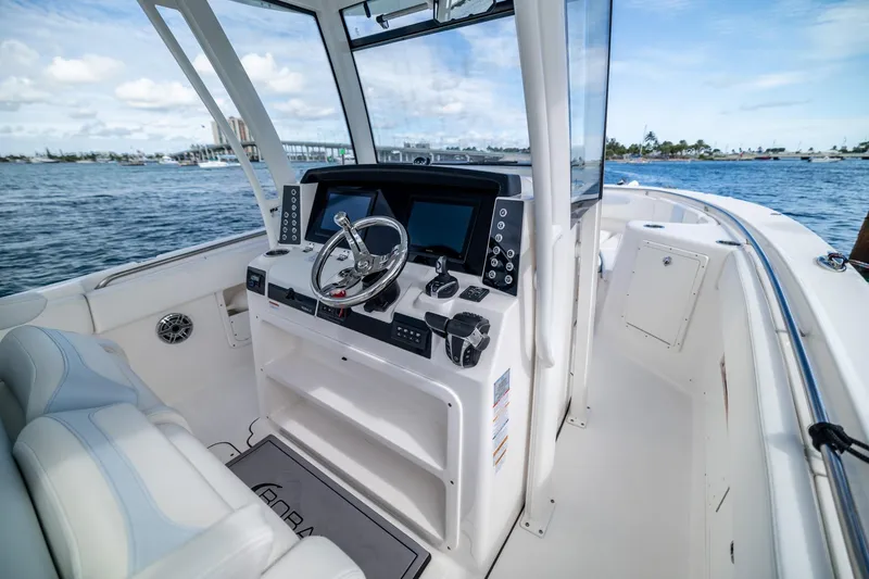 Slide: The Image of 2023 Robalo R302 Center Console boat interior with modern helm and ocean view. - 19