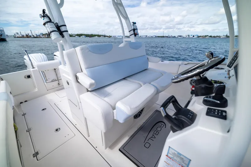 Slide: The Image of 2023 Robalo R302 Center Console boat interior with steering wheel and seating. - 20