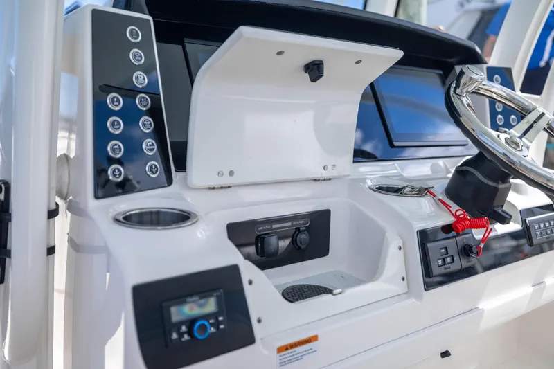Slide: The Image of 2023 Robalo R302 Center Console dashboard with steering wheel and control panel. - 23