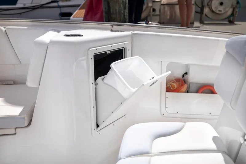 Slide: The Image of 2023 Robalo R302 Center Console boat interior with storage compartment open. - 29