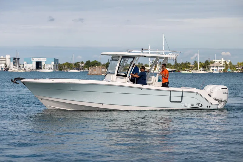 Slide: The Image of 2023 Robalo R302 Center Console boat cruising on calm waters. - 3