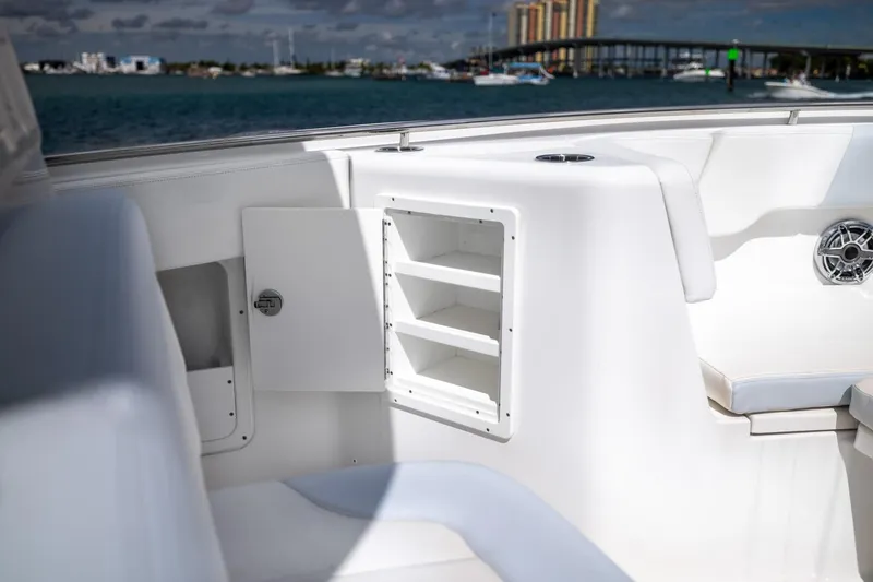 Slide: The Image of 2023 Robalo R302 Center Console boat interior with storage compartments and seating. - 30