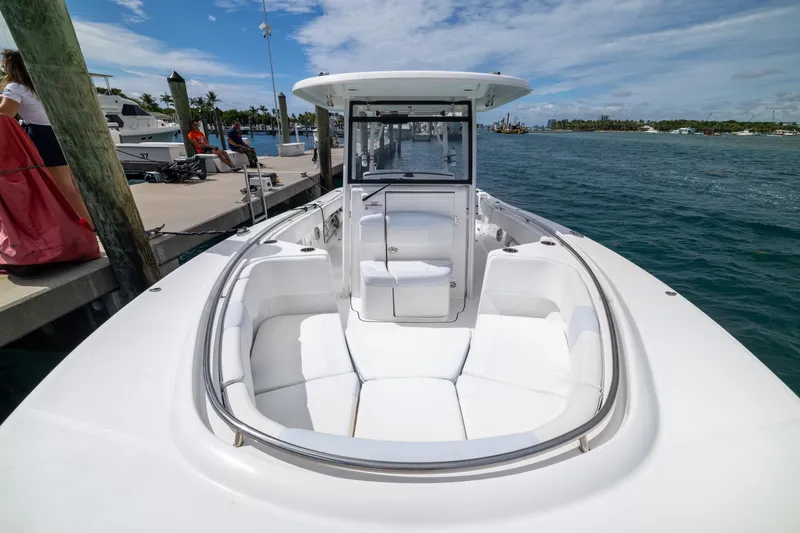 Slide: The Image of 2023 Robalo R302 Center Console boat docked, featuring spacious seating and sleek design. - 33